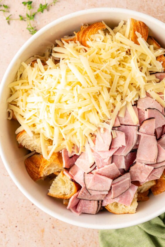 Deli ham and shredded cheese in a bowl.