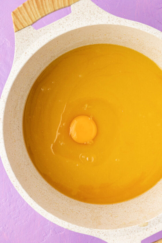 Egg in a pot with melted butter and sugar.