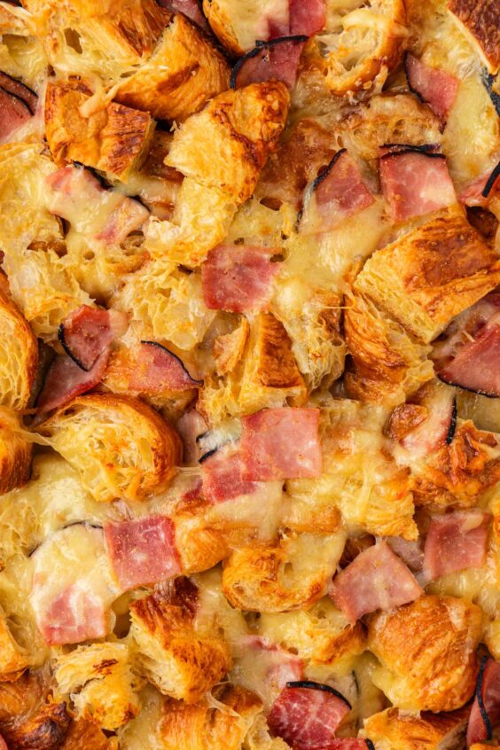 Close up of baked ham and cheese croissant casserole.