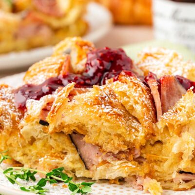 Close up of a slice of monte cristo breakfast casserole on a plate.