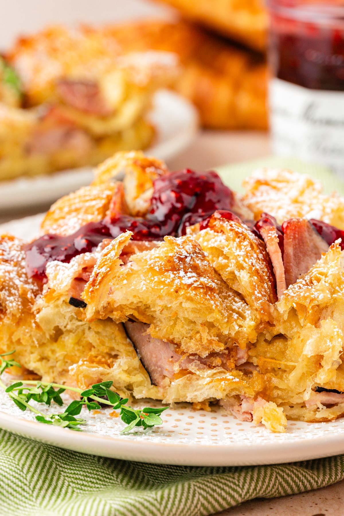 Close up of a slice of monte cristo breakfast casserole on a plate.