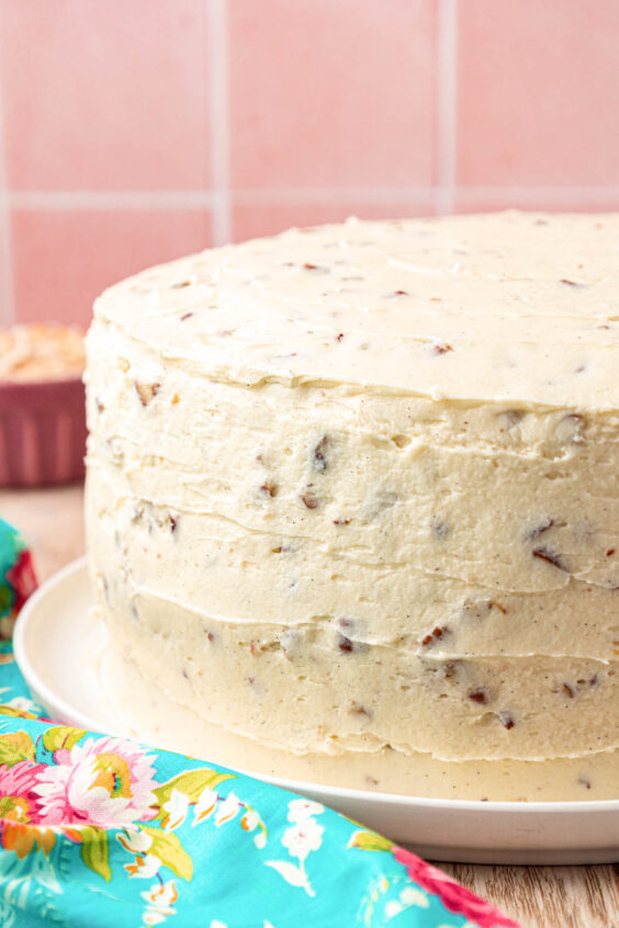 Italian Cream Cake with a crumb coat on a white plate.