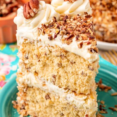 A slice of Italian Cream Cake on a teal plate.