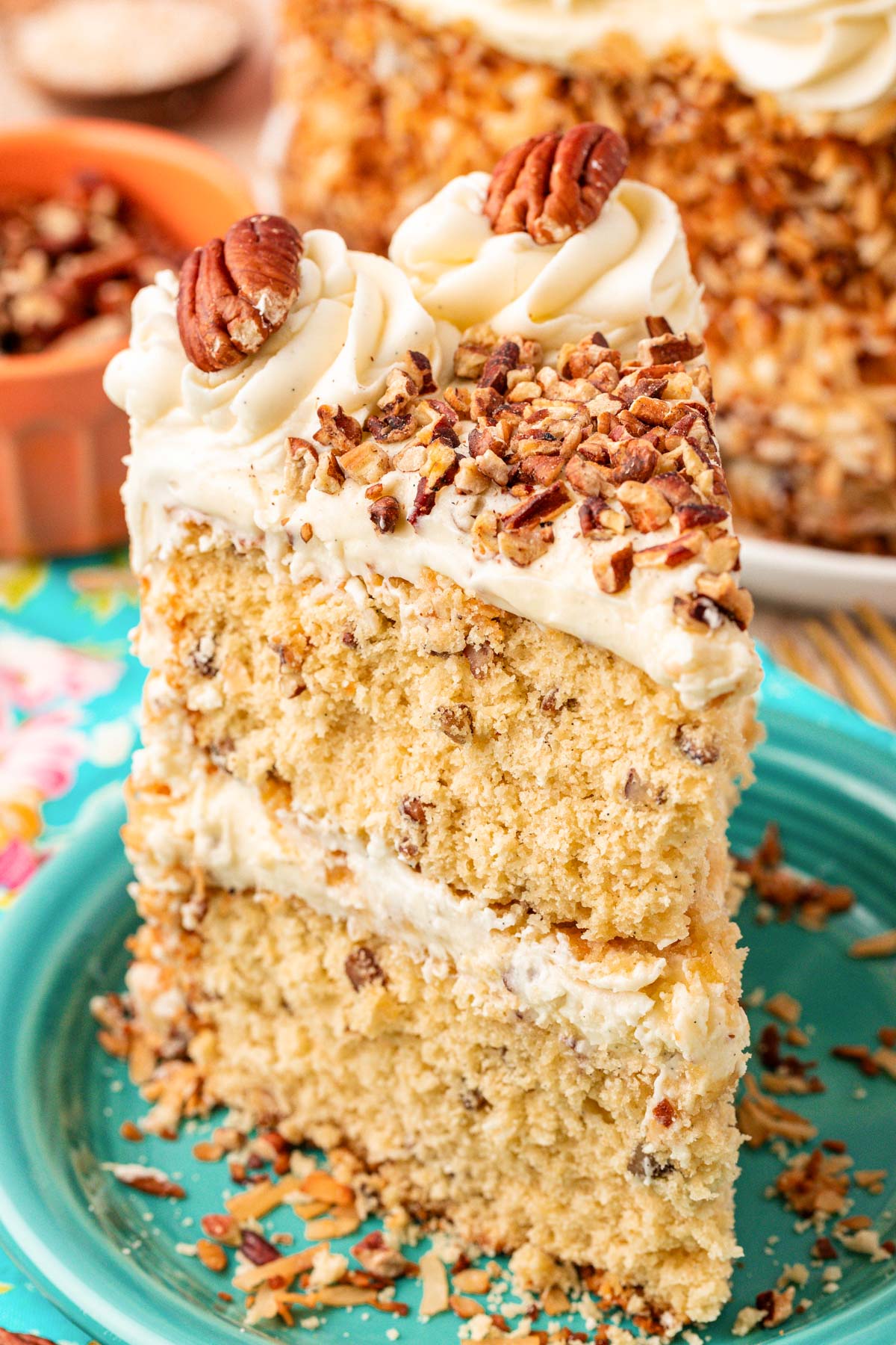 A slice of Italian Cream Cake on a teal plate.