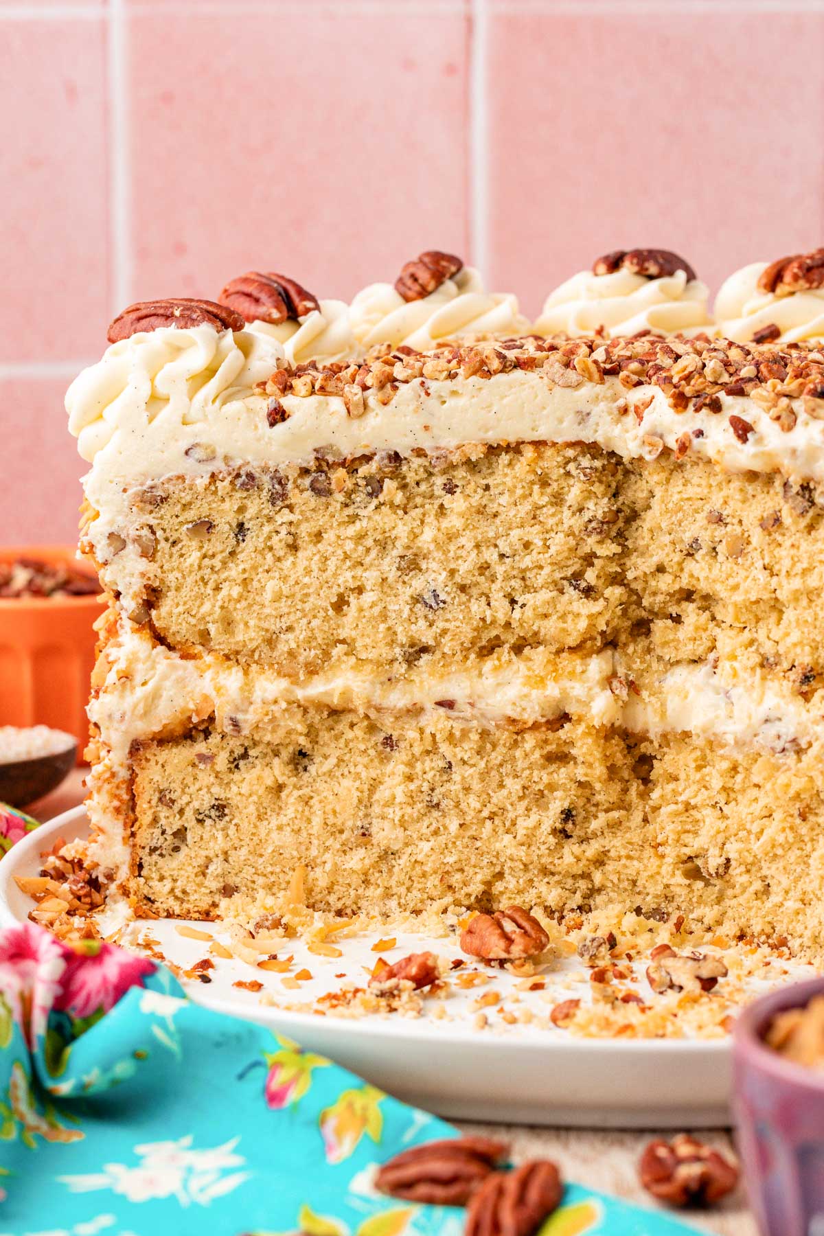 An Italian Cream Cake that's been cut with slices removed. 