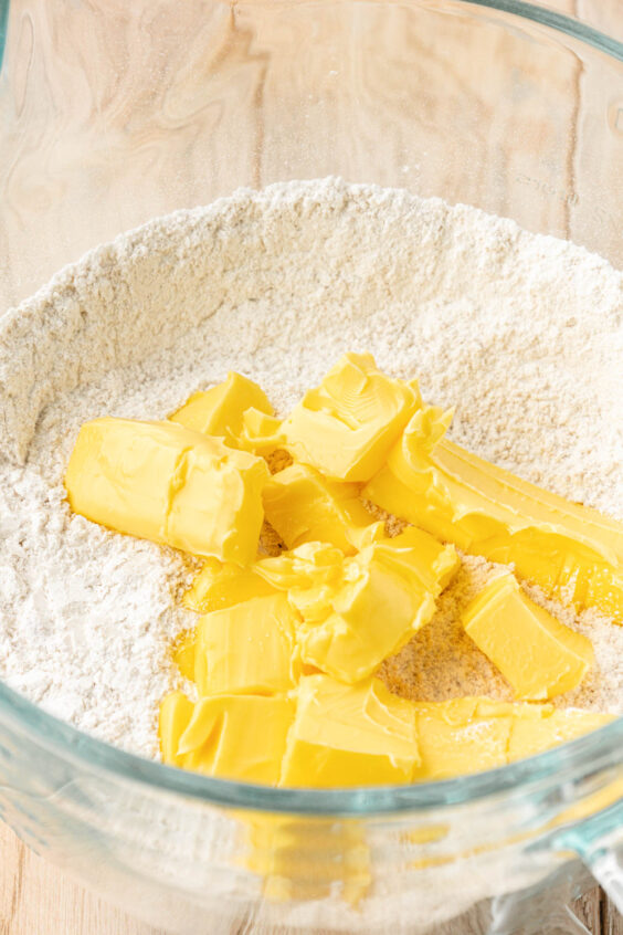 Soft butter being added to dry ones to make cake.