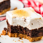 Close up of a s'mores brownie on a plate with a bite missing.