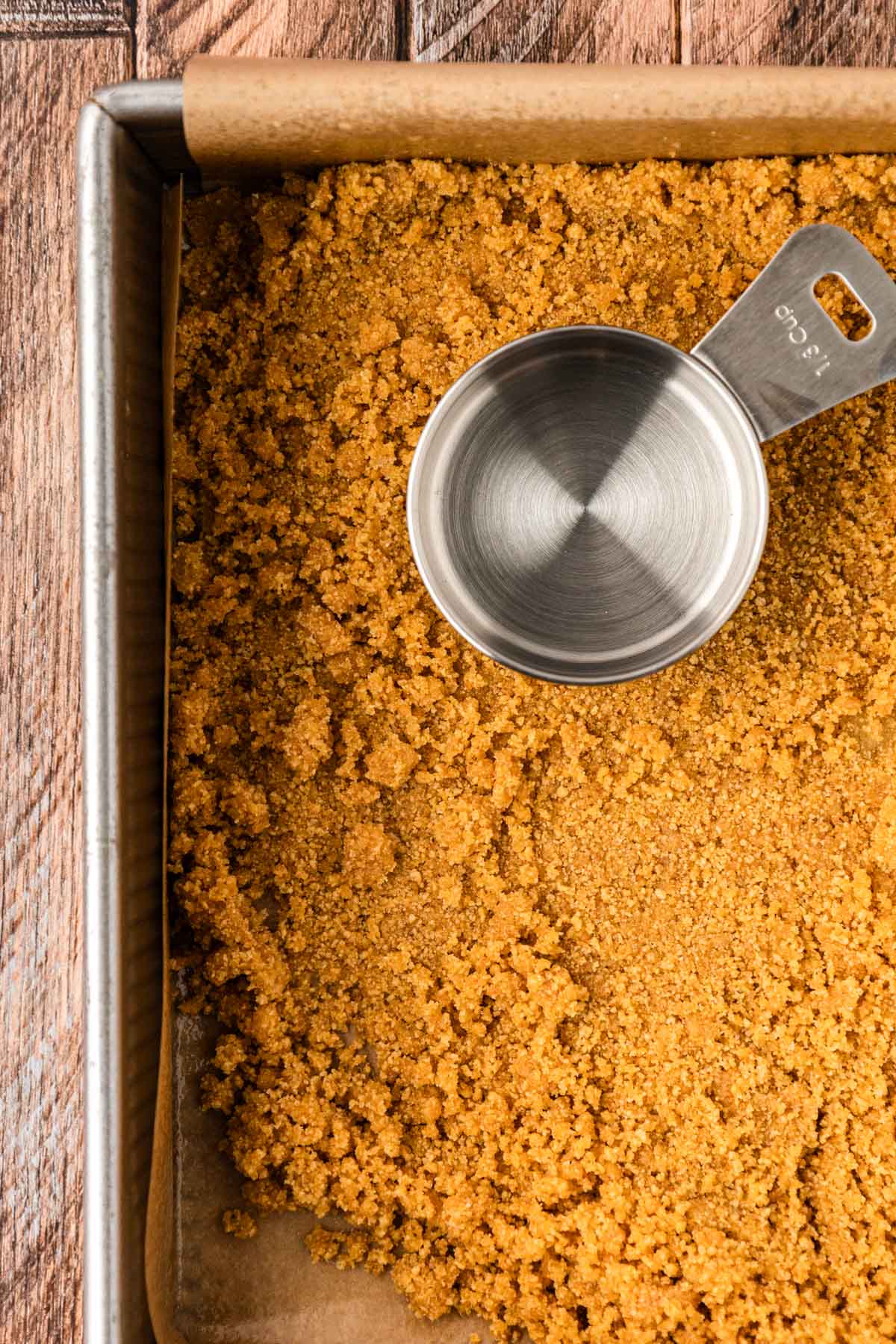 Graham cracker crust in a pan.