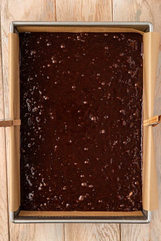 Brownie batter in a 9x13-inch pan ready to bake.