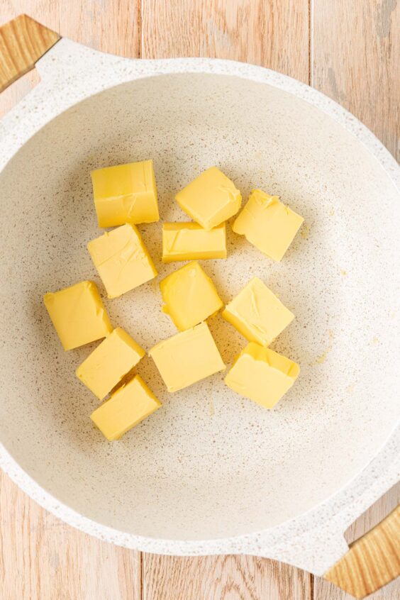 Butter ready to be melted in a pot.