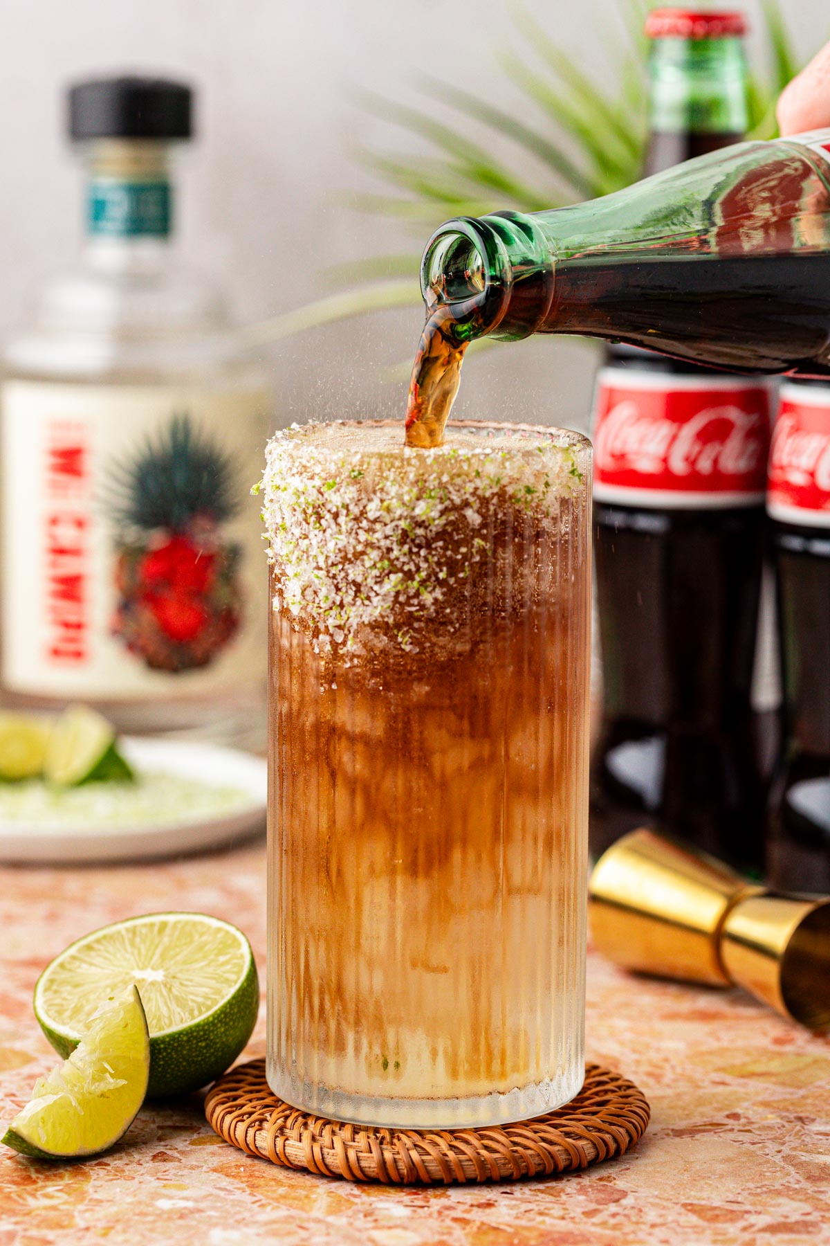 Coke being poured into a glass to make a Batanga.