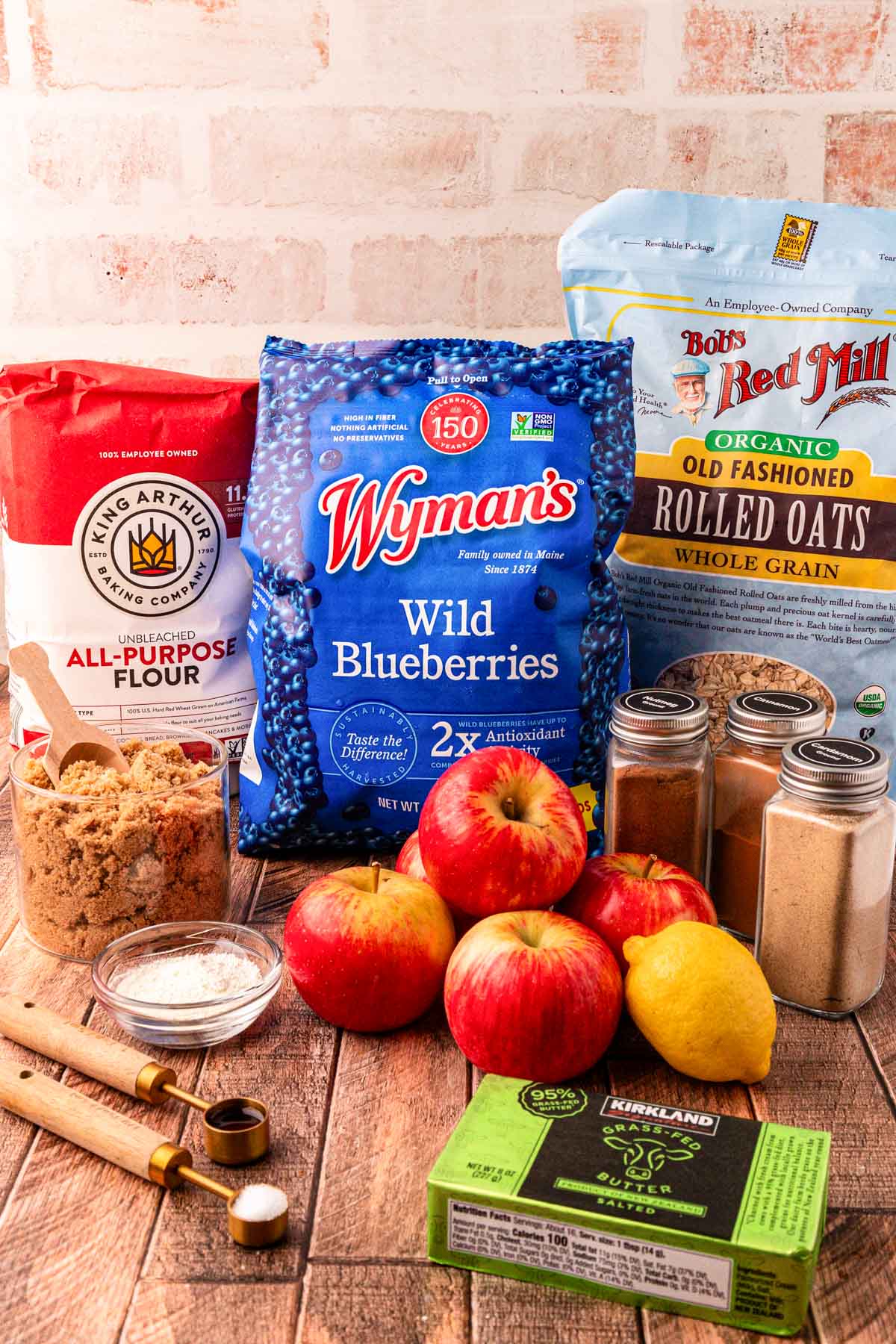 Ingredients for blueberry apple crisp on a wooden table.