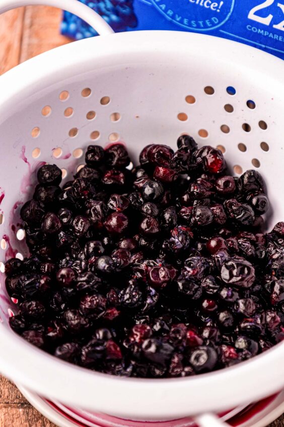 Frozen blueberries in a colander.