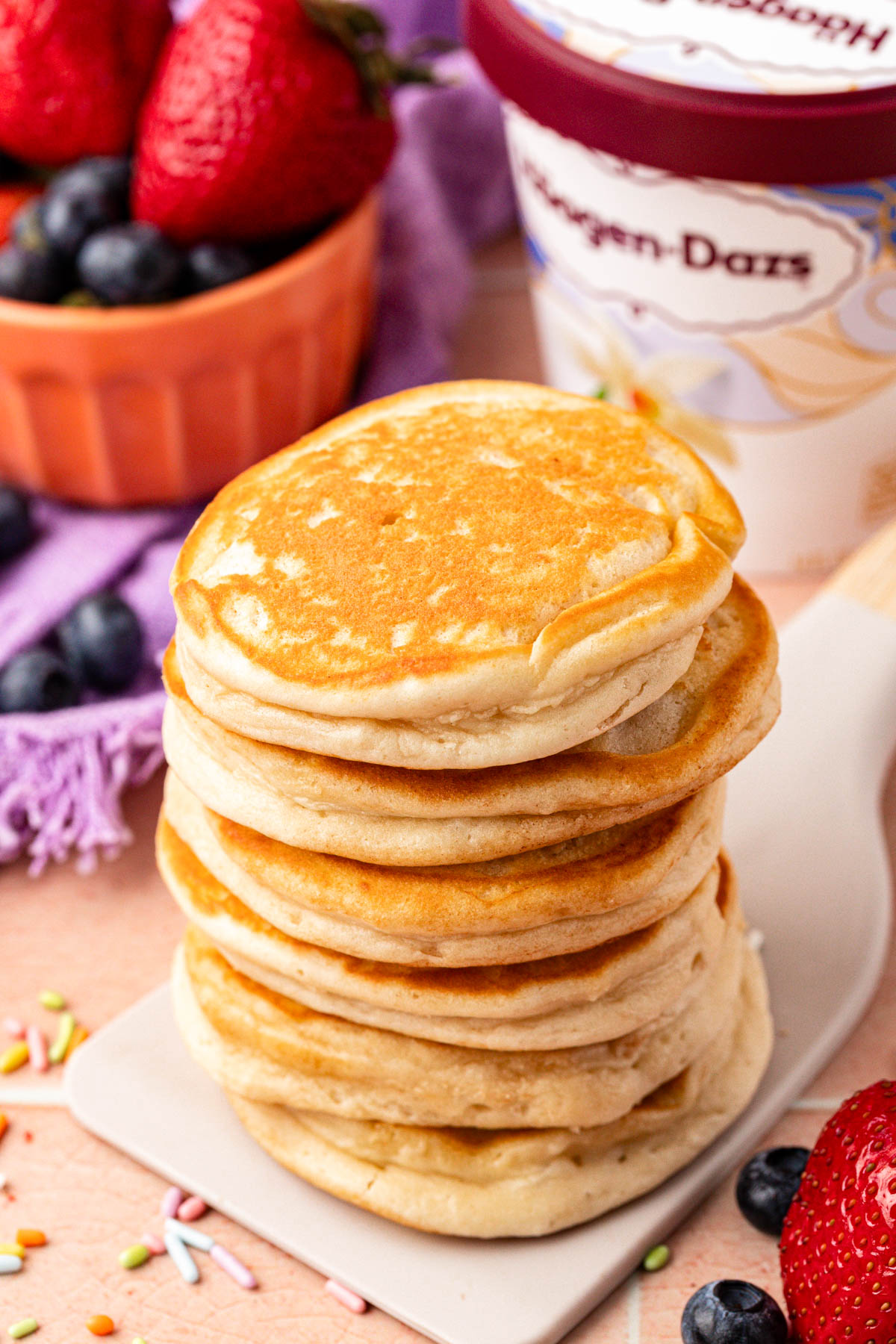 A stack of pancakes on a spatula.