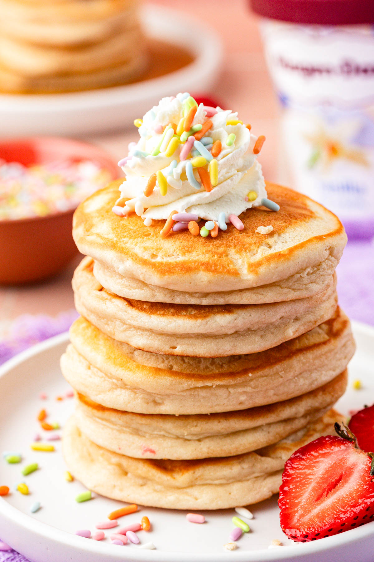 Close up of a stack of ice cream pancakes on a plate.