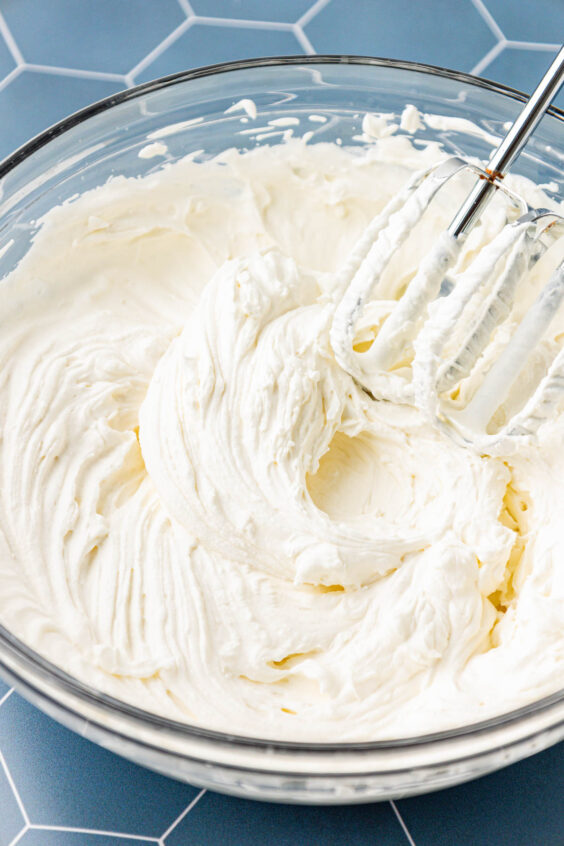 Whipped cream just beaten in a bowl.