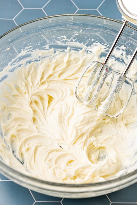 Cream cheese and sugar beaten in a mixing bowl.