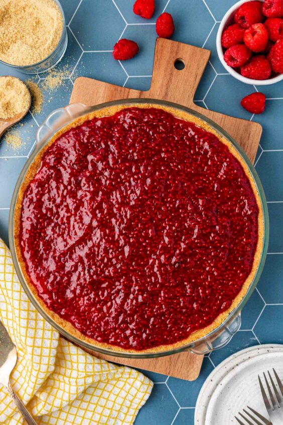 Raspberry cream pie on a serving board.