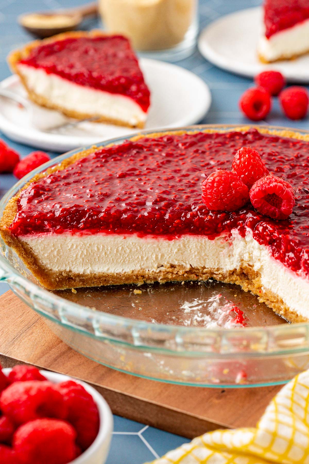 Close up of a raspberry cream pie with slices missing from the dish.