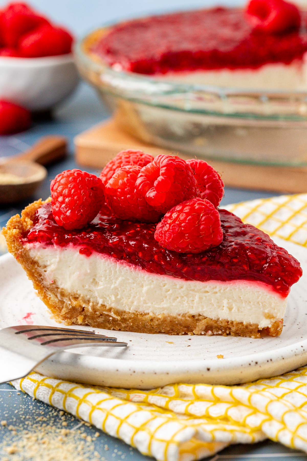 A slice of raspberry cream pie on a white plate.