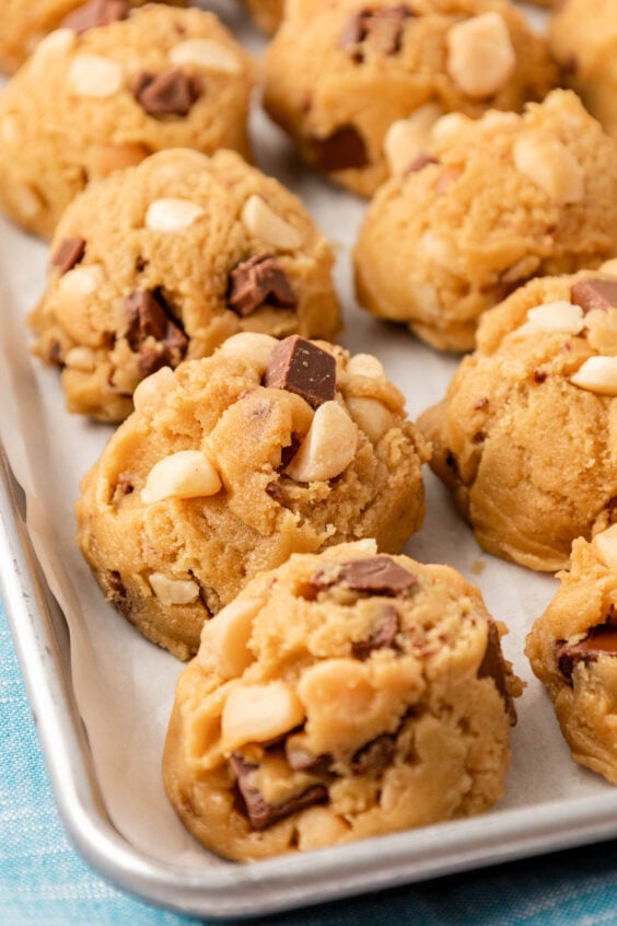 Close up of balls of cookie dough on a sheet pan ready to chill.