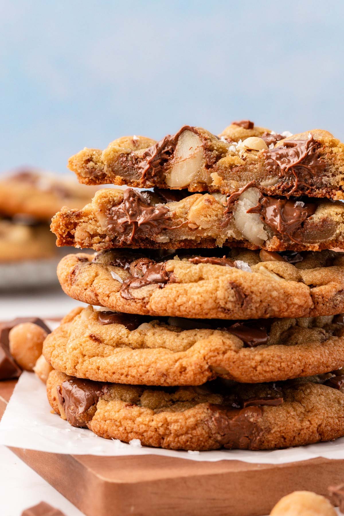 Sausalito Macadamia Nut Cookies stacked on a wooden board.