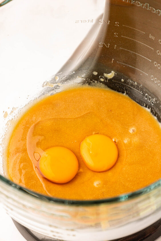 Eggs in a bowl of cookie dough ready to be mixed in.