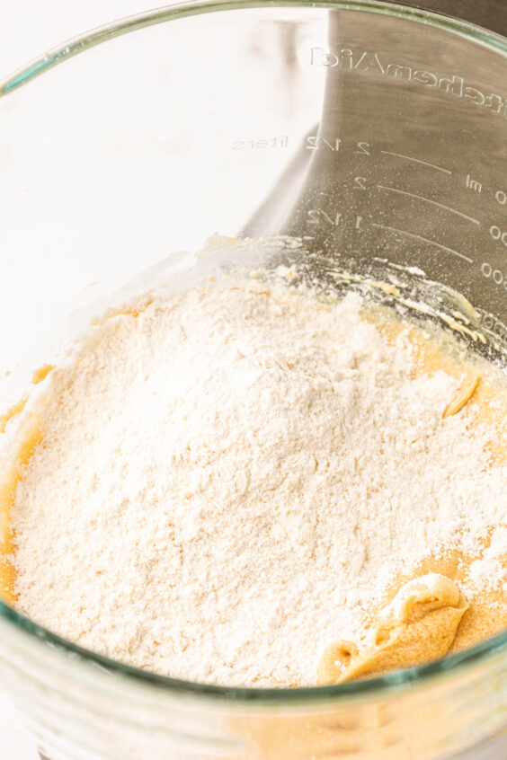 Dry ingredients being added to wet ingredients to make cookie dough.