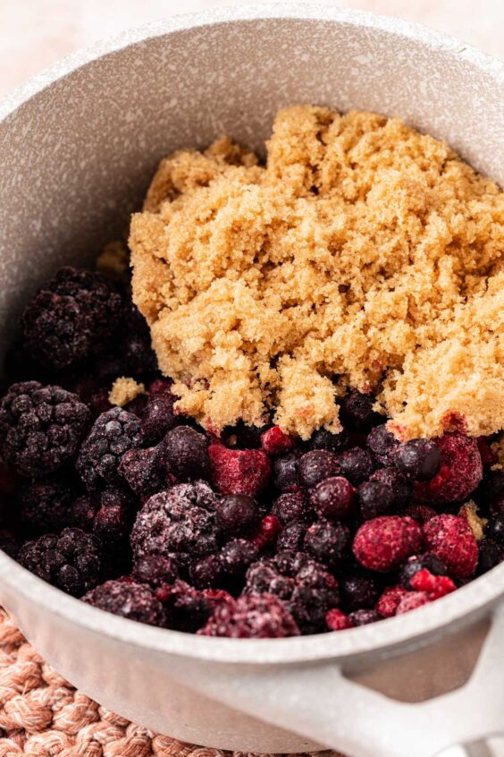 Ingredients for mixed berry compote in a pot ready to cook.