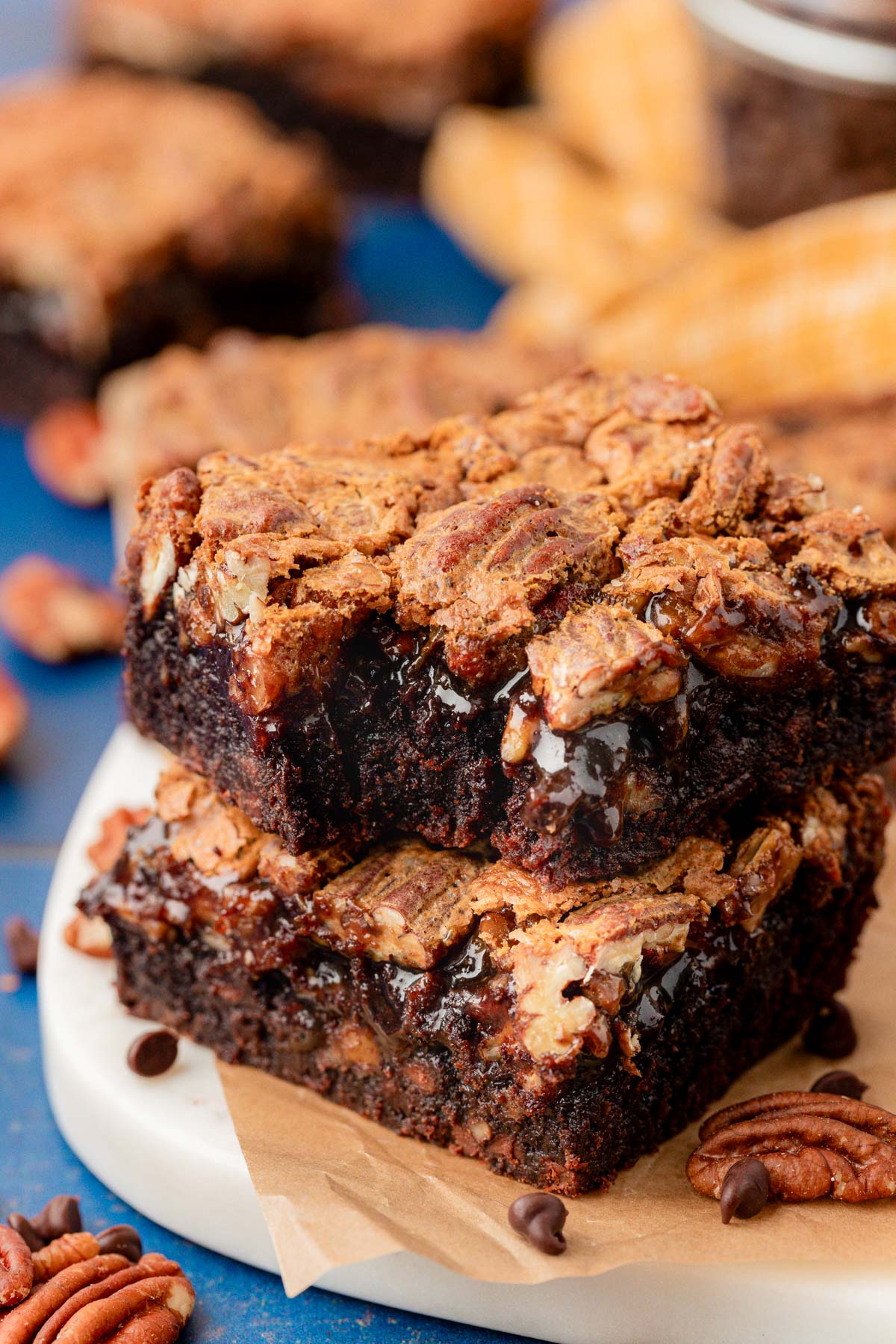 Close up of pecan pie brownies stacked on a plate.