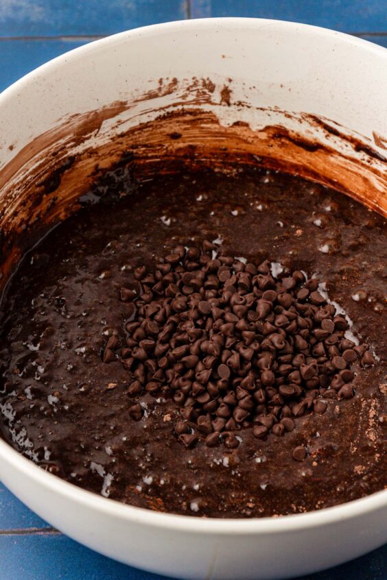 Mini chocolate chips in a bowl of brownie batter.