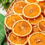 Dried sliced oranges on a wire rack.