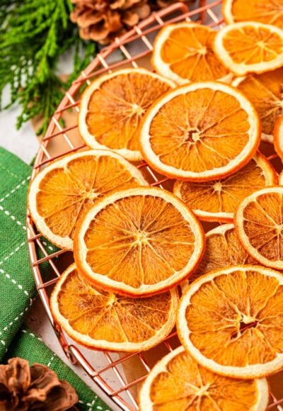 Dried sliced oranges on a wire rack.