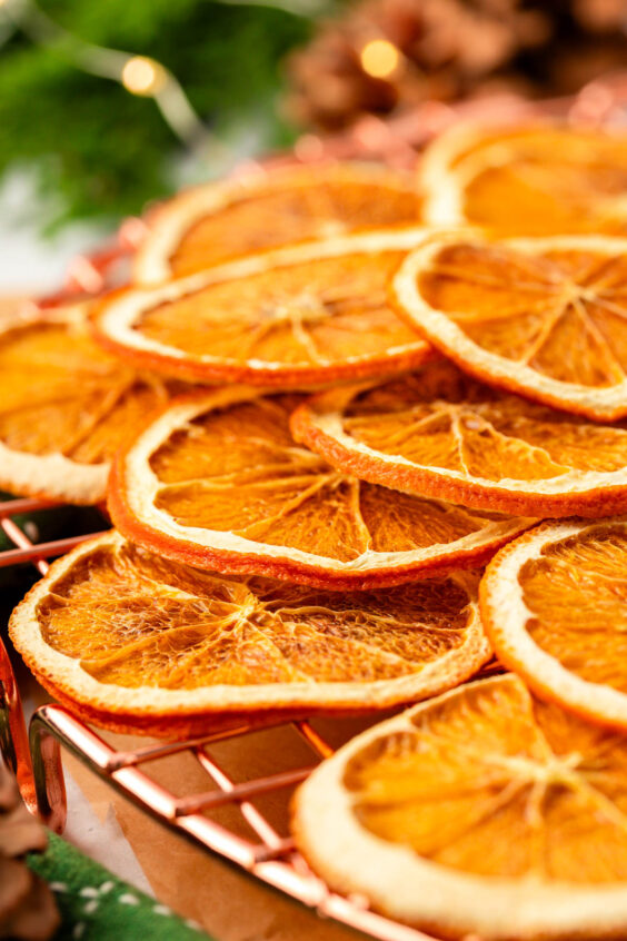 Dried orange slices on a wire rack.