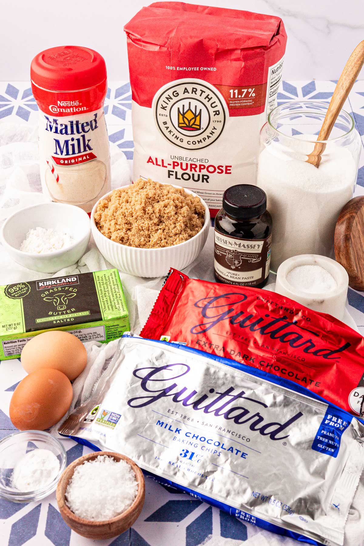 Ingredients to make chocolate chip cookies on a table.