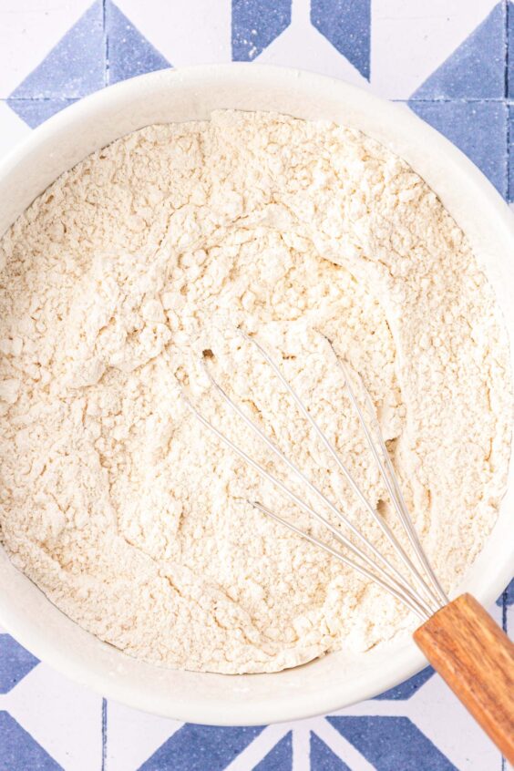 Dry ingredients being whisked in a mixing bowl.