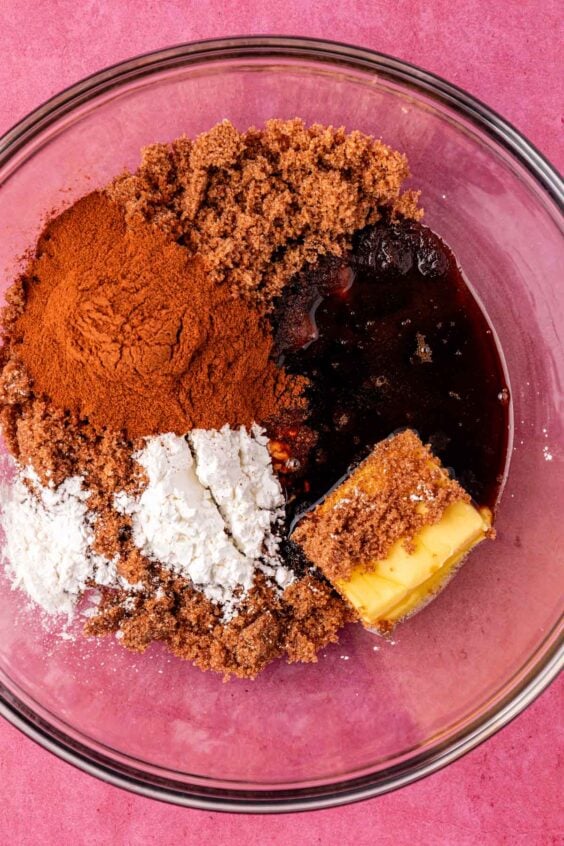 Ingredients to make cinnamon roll filling in a glass bowl.