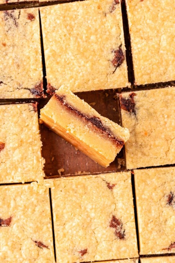 Shortbread bars with cinnamon filling sliced on a table.