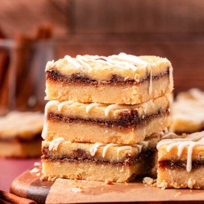 Close up of a stack of three cinnamon roll cookie bars on a table.