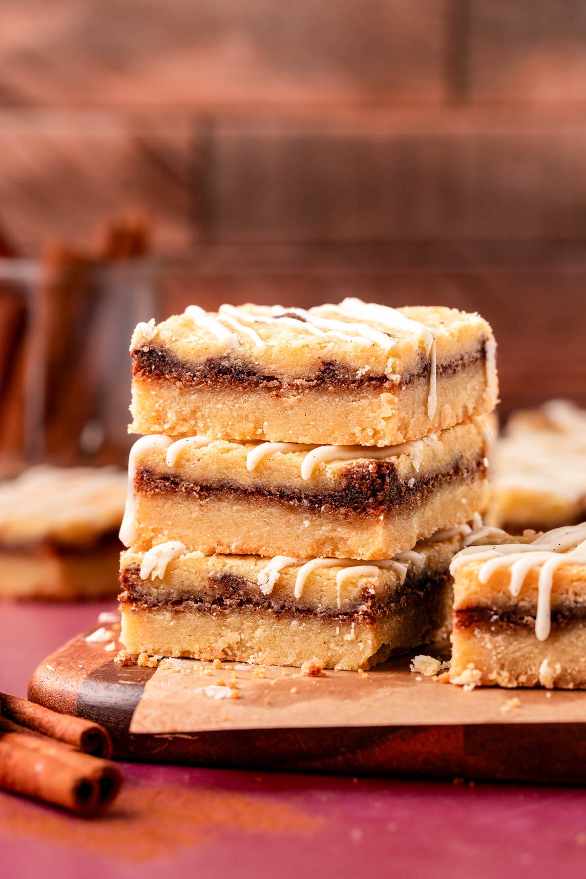 Close up of a stack of three cinnamon roll cookie bars on a table.