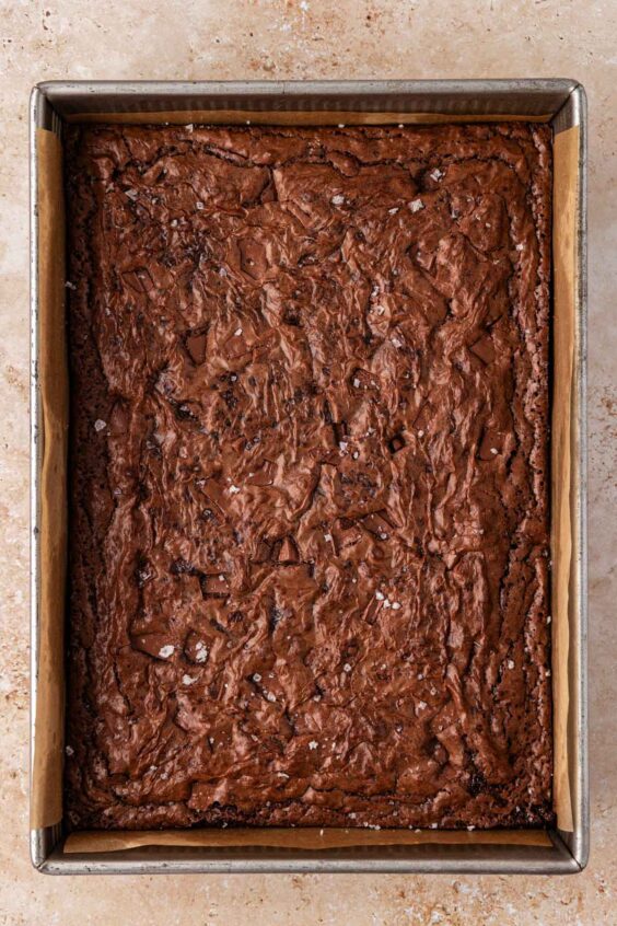 Baked pan of brownies sitting on a table.