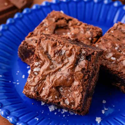 Close up of a pan of chocolate brownies on a blue plate.