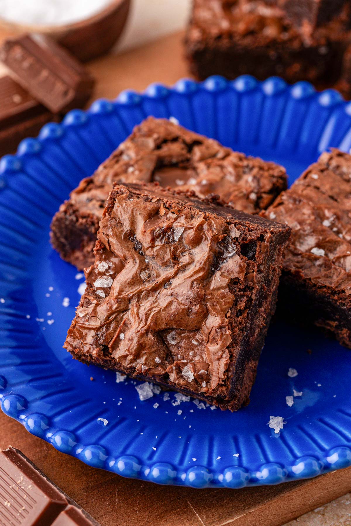 Close up of a pan of chocolate brownies on a blue plate.