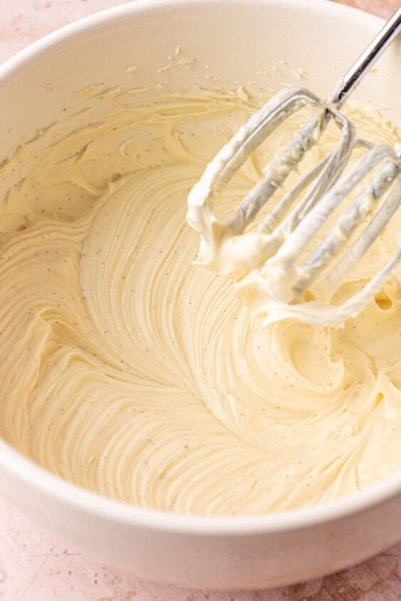 Cream cheese, powdered sugar, and vanilla beaten in a mixing bowl.