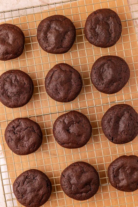 Chocolate cookies cooling on a wire rack.