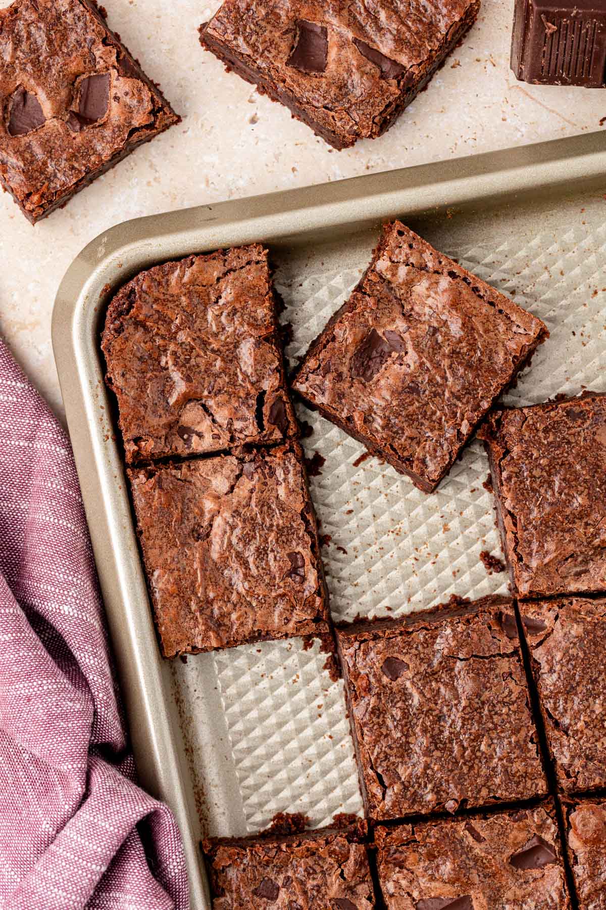 Overhead photo of a pan with cut brownies in it, some are missing.