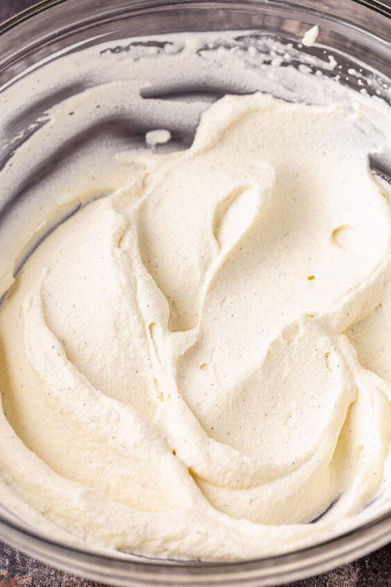 Peppermint whipped cream in a glass mixing bowl.