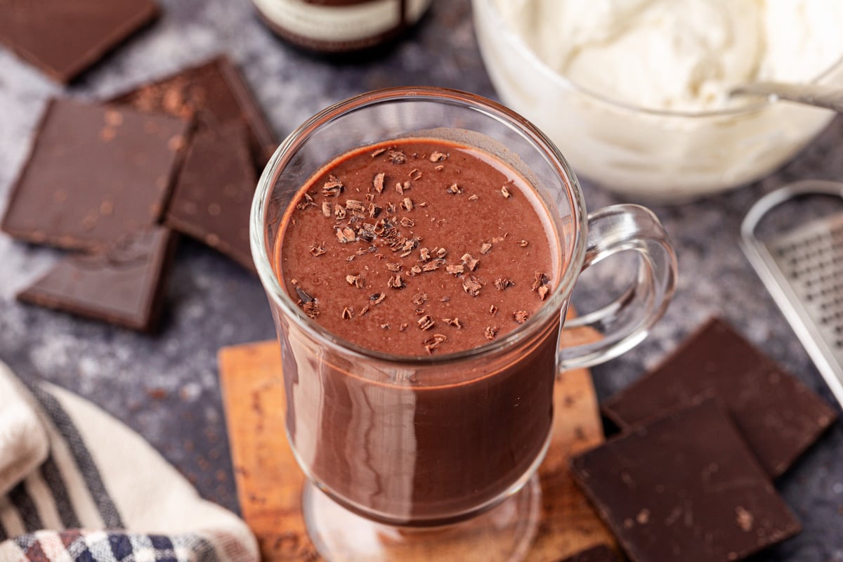 A mug of Tini's Hot Chocolate on a wooden coaster.