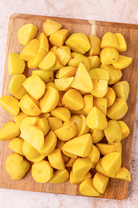 Potatoes chopped on a cutting board.