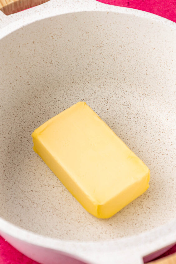 A block of butter in a large pot.